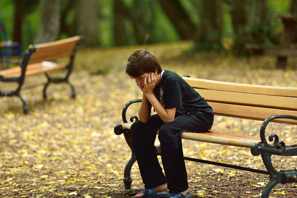 depressed young man sitting on the bench