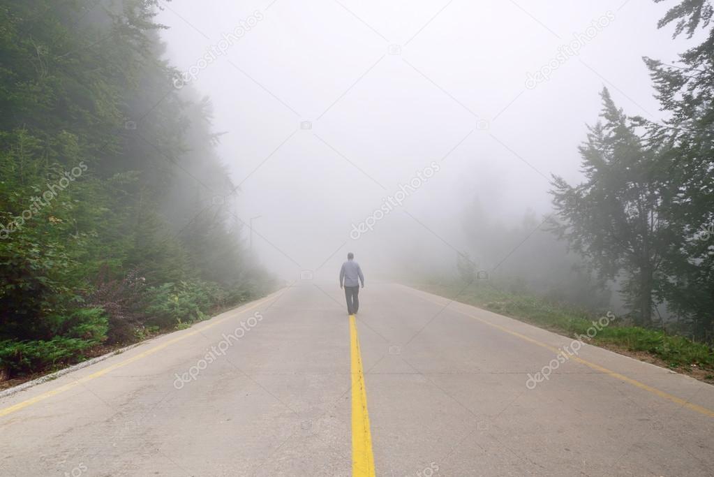 Silhouette of man in misty fog