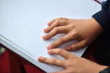 Blind child hand with a disability touch and read the cipher cod clipart