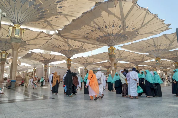 Pilgrims walk underneath giant umbrellas at Nabawi Mosque