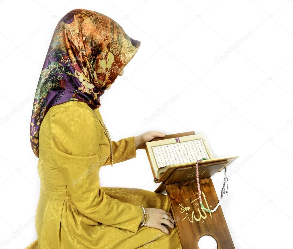 Muslim girl in hijab reading Al Quran on a white background