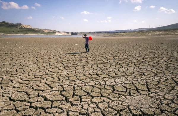 children walking on dry cracked surface