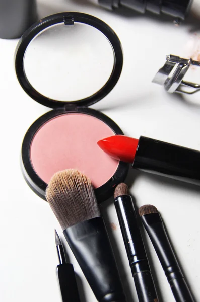 Red lipstick and mix of make up brushes — Stock Photo, Image