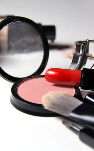 Red lipstick and mix of make up brushes — Stock Photo, Image