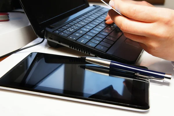 Office table with laptop and female hands — Stock Photo, Image