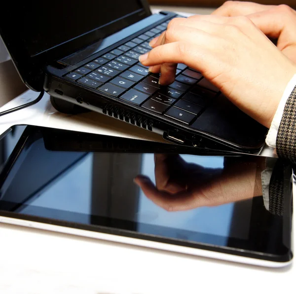 Office table with laptop and female hands — Stock Photo, Image