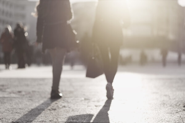 blur abstract people background, unrecognizable silhouettes of people walking on a street