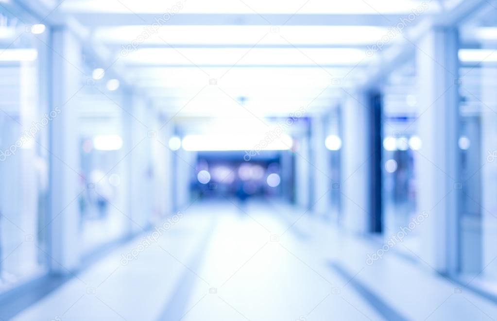 abstract defocused blurred background, empty business corridor or shopping mall. Medical and hospital corridor defocused background with modern laboratory (clinic)