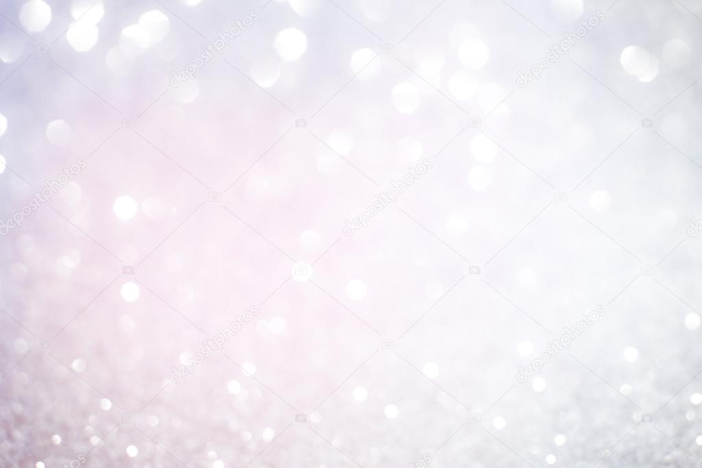 Silver white glittering Christmas lights. Blurred abstract backg