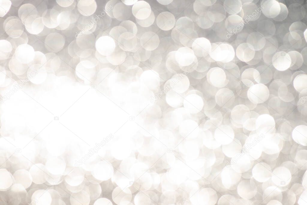 Silver white glittering Christmas lights. Blurred abstract background