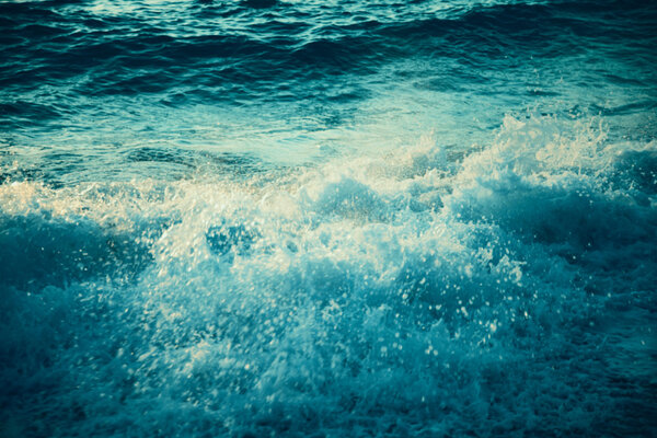 sea wave water splash at sunset