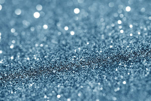 Blue glittering christmas lights. Blurred abstract background