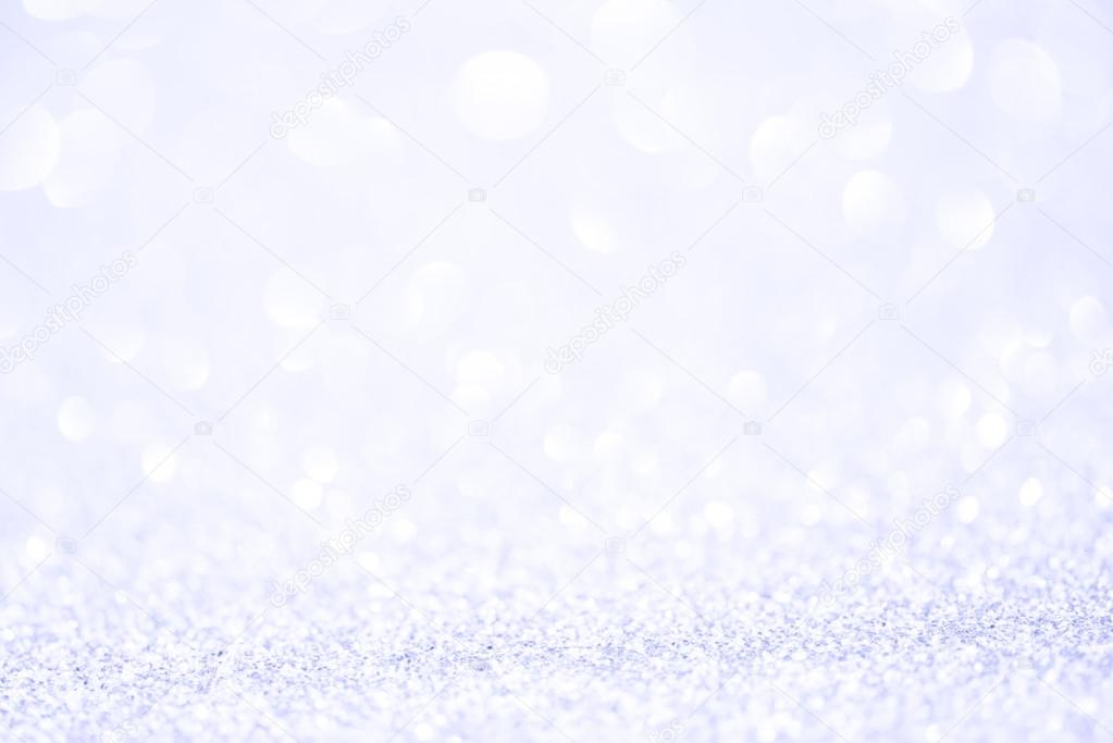 Silver white glittering Christmas lights. Blurred abstract background