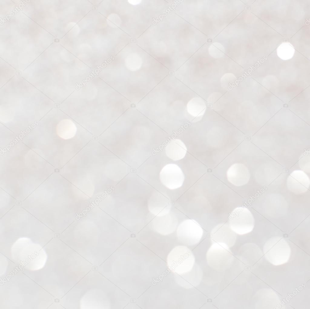 Silver white glittering Christmas lights. Blurred abstract backg