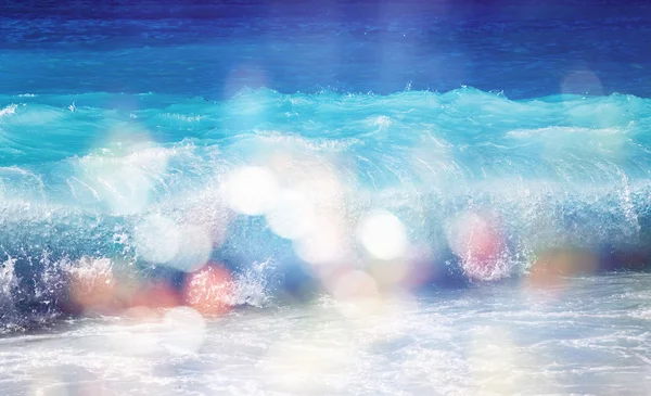 Background of blurred beach and sea waves with bokeh lights — Stock Photo, Image