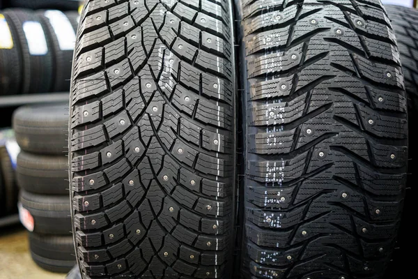 Closeup view of two studded winter tires with different treads — Stock Image Closeup View Two Studded Winter Tires Different Treads Stock Image