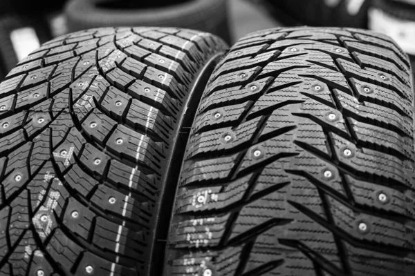 Closeup view of two studded winter tires with different treads — Stock Image Closeup View Two Studded Winter Tires Different Treads Royalty Free Stock Images