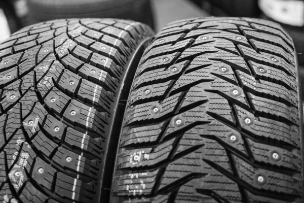 Closeup view of two studded winter tires with different treads — Stock Image Closeup View Two Studded Winter Tires Different Treads Royalty Free Stock Photos