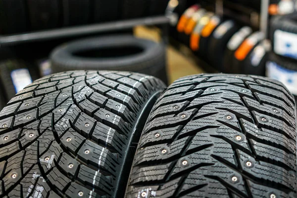 Closeup view of two studded winter tires with different treads — Stock Image Closeup View Two Studded Winter Tires Different Treads Royalty Free Stock Photos