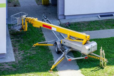 inspection of the house facade with the help of a modern mobile self propelled hydraulic lifting platform