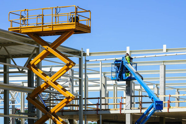 Modern mobile self propelled hydraulic lifting platform and scissor lift in action