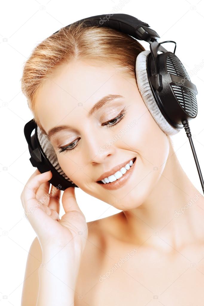 pleasant music.Smiling girl in headphones.