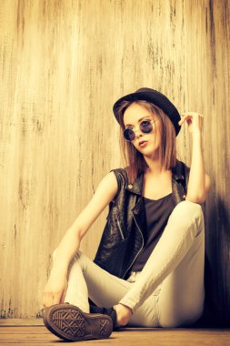 Kız bir yere oturur