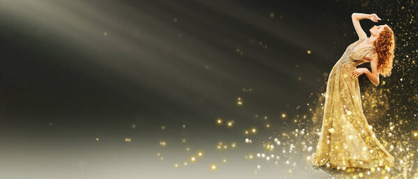 Beauty, evening fashion.  Full length portrait of a beautiful red-haired woman in a luxury golden dress surrounded by festive golden lights. Christmas fashion. 