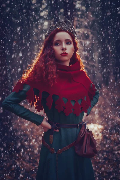 Fantasy world. Beautiful red-haired princess in a deep winter forest. Ancient times. Celts.