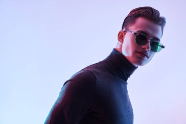 Modern güneş gözlüklü yakışıklı genç adam. Erkek aksesuarları, optikler. Stüdyo portresi. Boşluğu kopyala. 