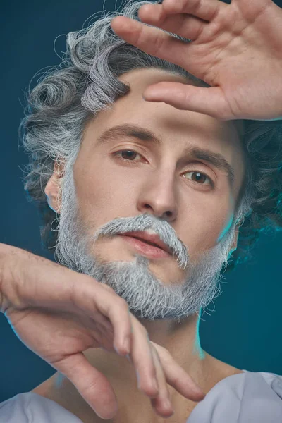 Art image of God. Divine man with a beard and curly hair on a blue background. Roman and Greek mythology, Christianity and religion.