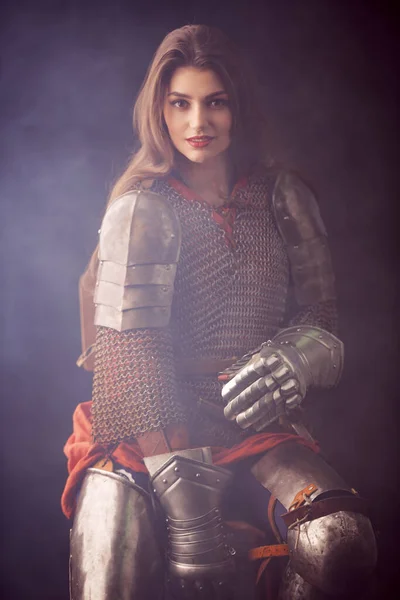 Portrait of a beautiful female knight in armor of noble birth in haze. History of the Middle Ages.