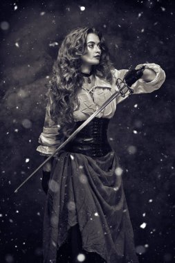 Black-and-white portrait of a beautiful woman with a battle epee (rapier) standing under the snow. The heroine of an adventure novel. clipart