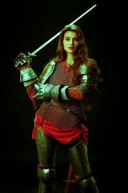 Era of romanticism. Portrait of a beautiful female knight in armor of noble birth holding a sword. The Middle Ages history. clipart