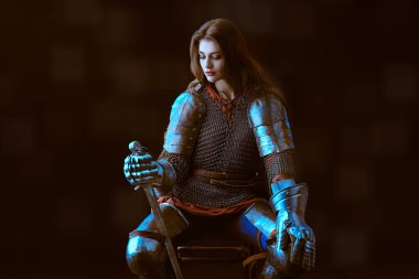 Era of romanticism. Portrait of a beautiful female knight in armor of noble birth. The Middle Ages history. clipart