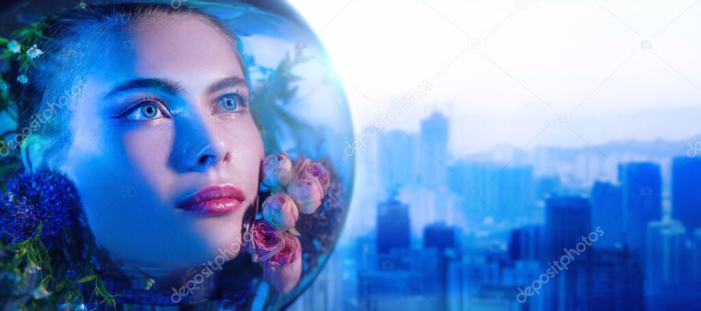 Environmental disaster, air pollution. Beautiful girl in a spacesuit filled with flowers looks up with hope against the backdrop of a large industrial city. Copy space.  