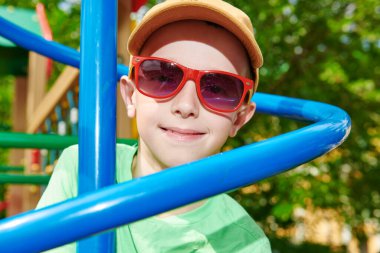 Mutlu çocuk dinleniyor ve parkta oyun parkında eğleniyor. Yaz tatili. Mutlu çocukluk.