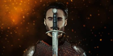 Close up portrait of a medieval knight with sword and armour on a black background with sparks of fire. clipart