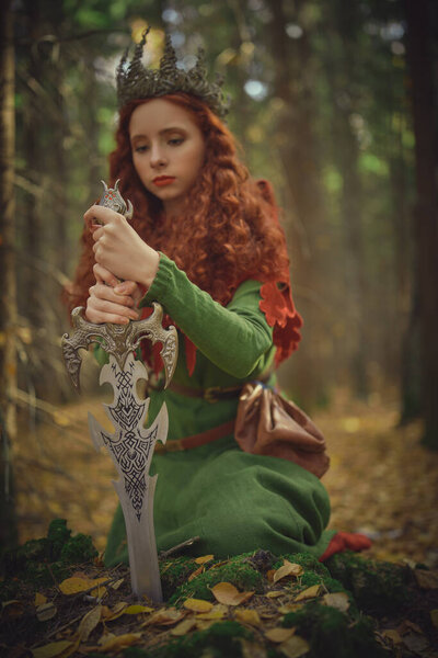 A beautiful queen warrior woman with a sword in a deep forest. Ancient legends. Fantasy world.