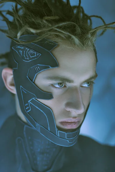 Close-up portrait of a courageous cyberpunk warrior wearing a protective mask in neon light. Cyberpunk concept. World of the future. Game, virtual reality.