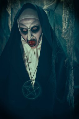 Korkunç rahibe kanlı dişleri açıkta duruyor. Cadılar Bayramı ve Dehşet.