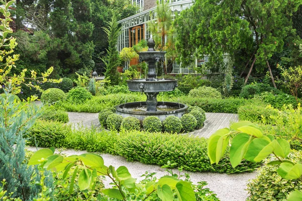 Nature background. Fountain in english garden design. Royaltyfria Stockfoton