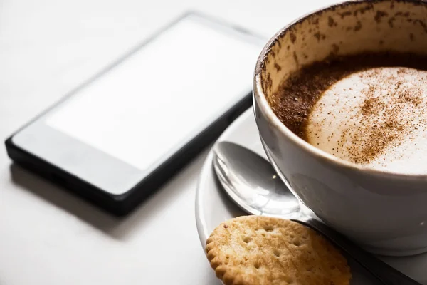 Cappuccino cup of coffee and cracker with phone isolated on whit — Stock Photo, Image