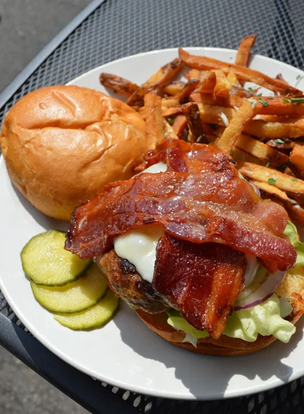 Bacon cheese burger with a side of fries — Stock Photo, Image