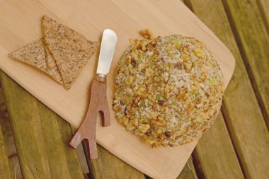 Vegan Cheese Ball as side dish on rustic table clipart