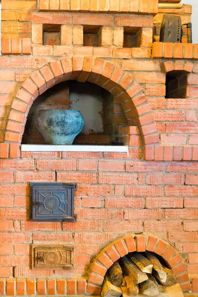 Old red brick oven and a pot with food — Stock Photo, Image