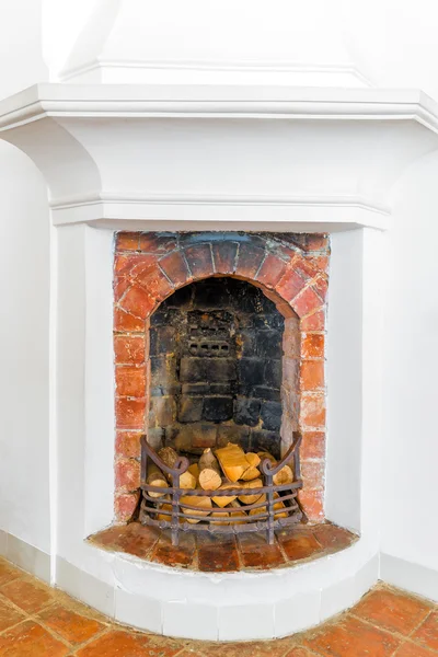 Brick fireplace with firewood in the house — Stock Photo, Image