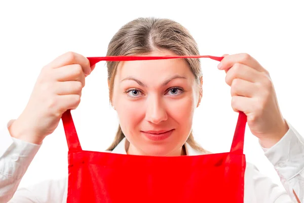 Young brunette wears a red apron isolated — Stock Photo, Image