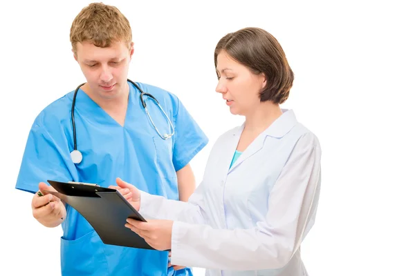 Couple of doctors discussing a diagnosis written in the folder — Stock Photo, Image