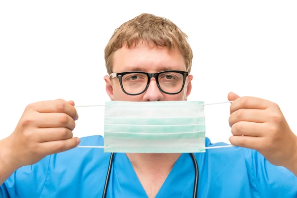 Doctor puts on face protective mask on a white background — Stock Photo, Image